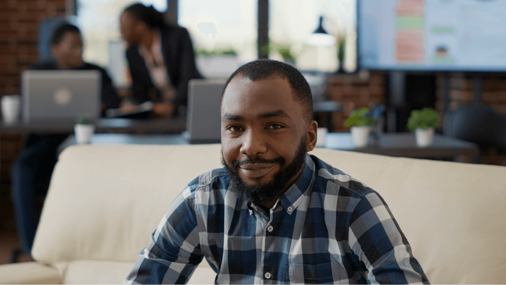 portrait-african-american-person-smiling-office-sitting-couch-work-laptop-company-employee-using-financial-statistics-create-job-development-business-growth portrait-african-american-person-smiling-office-sitting-couch-work-laptop-company-employee-using-financial-statistics-create-job-development-business-growth